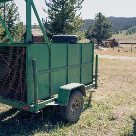 A Wyoming Game and Fish employee approaches an empty bear trap trailer used to capture grizzly bears for management action.